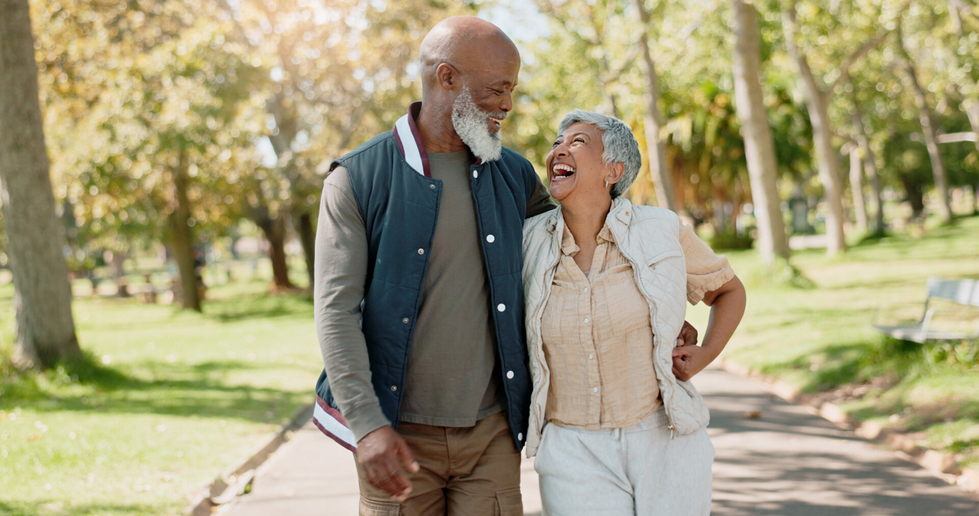 Senior couple living at Traditions at Brookside enjoying a walk on the paved community walking paths