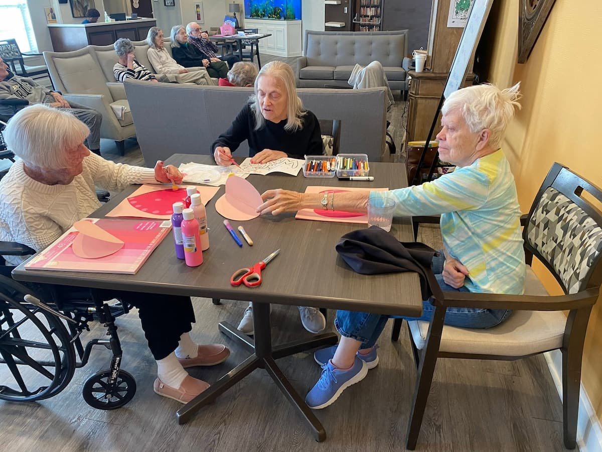 Residents create handmade Valentine’s Day cards during a holiday craft activity at Traditions at Brookside.
