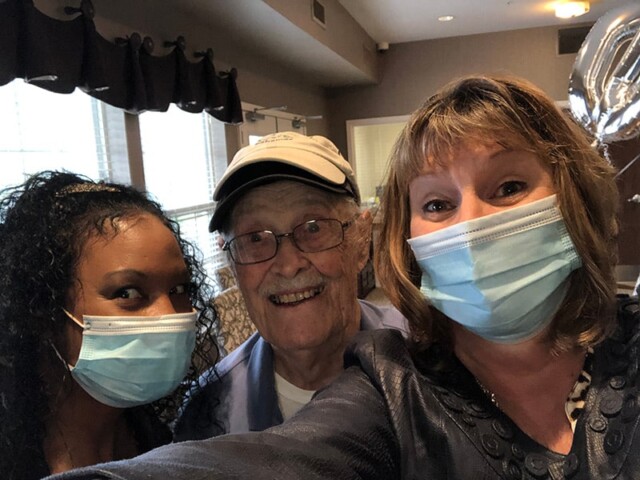 Three people take a selfie together