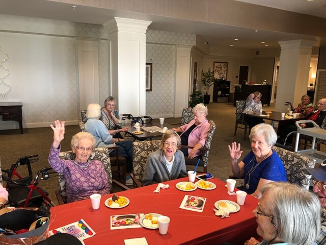 Elderly people are sat at table for Bill